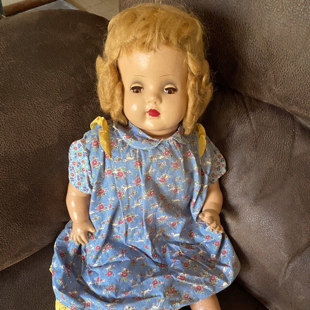 Vintage 23” Composition babydoll in blue flowered dress.